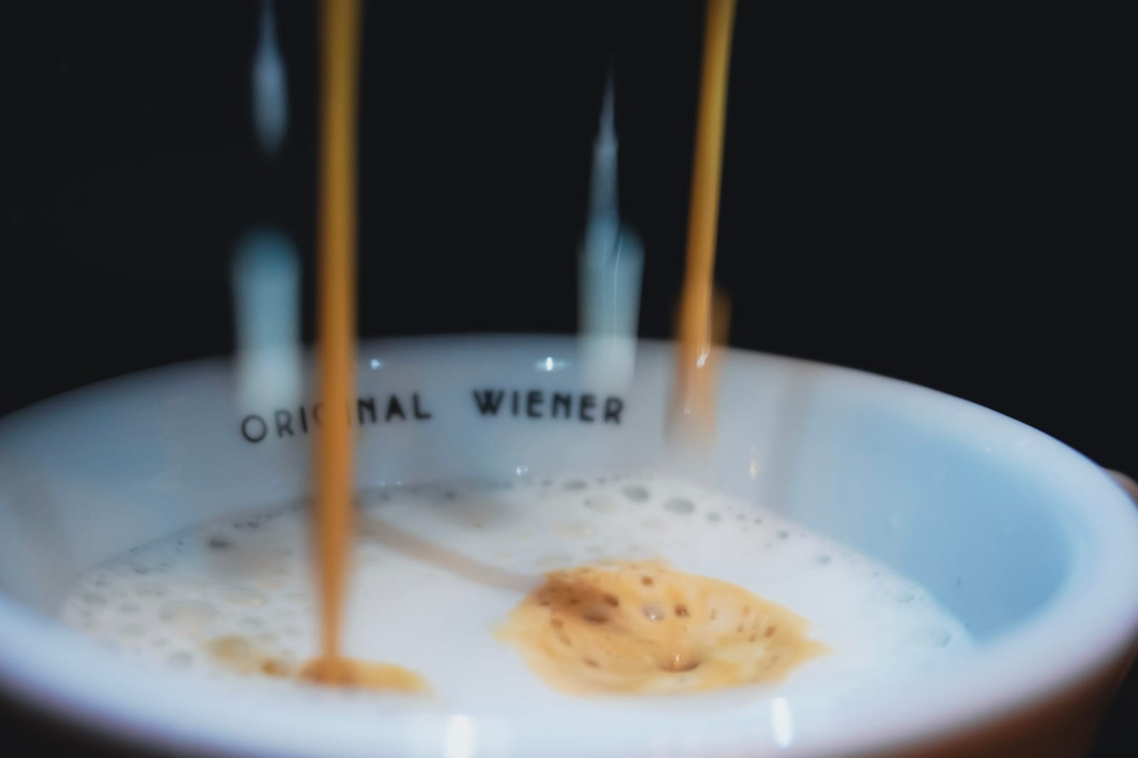 An espresso pouring into an Original Wiener cup