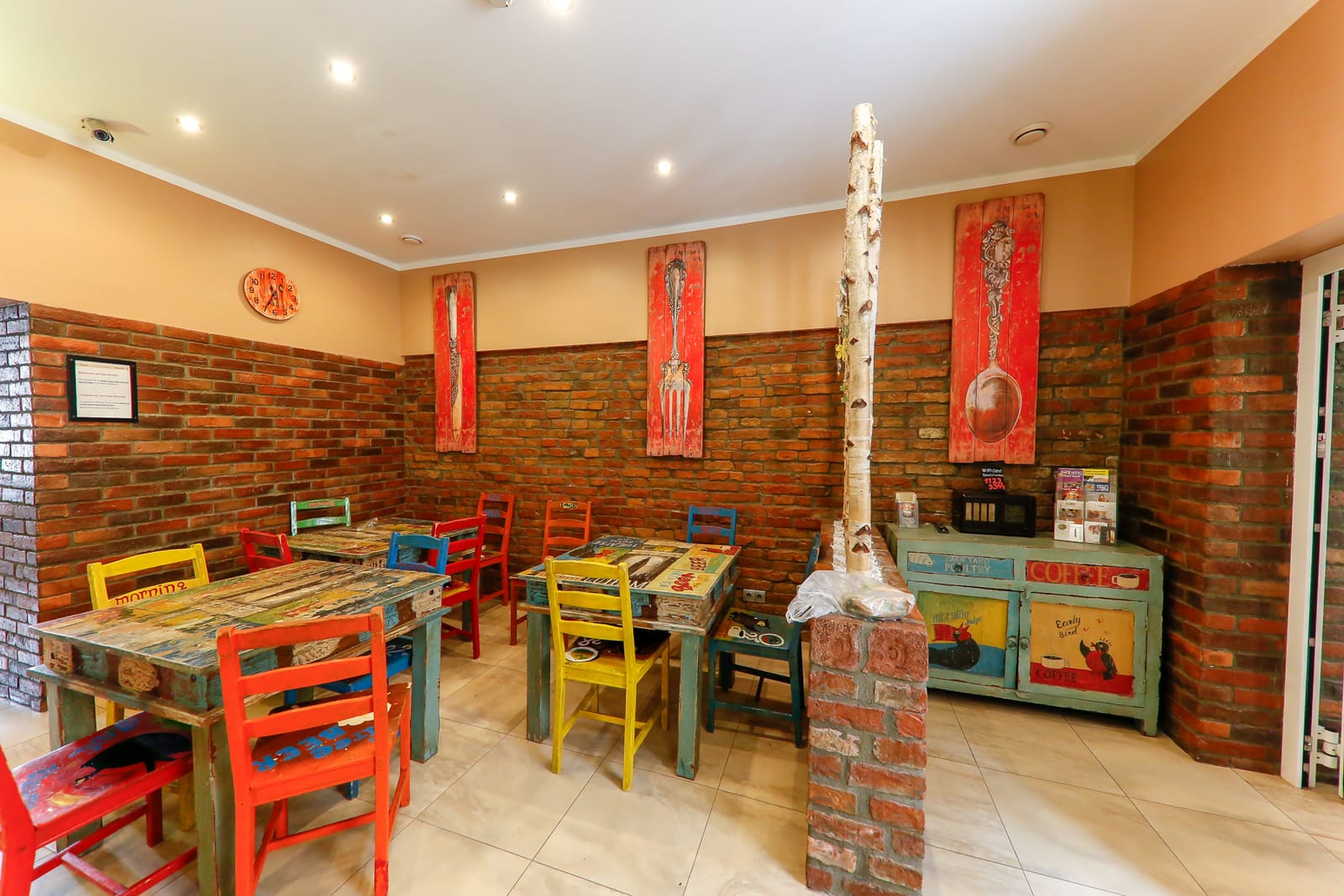 Colourful breakfast room with brick walls